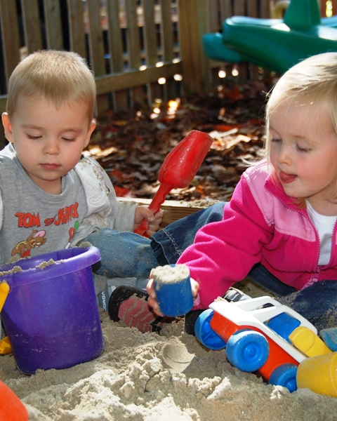Good weather takes the toddlers outside into the sandbox.